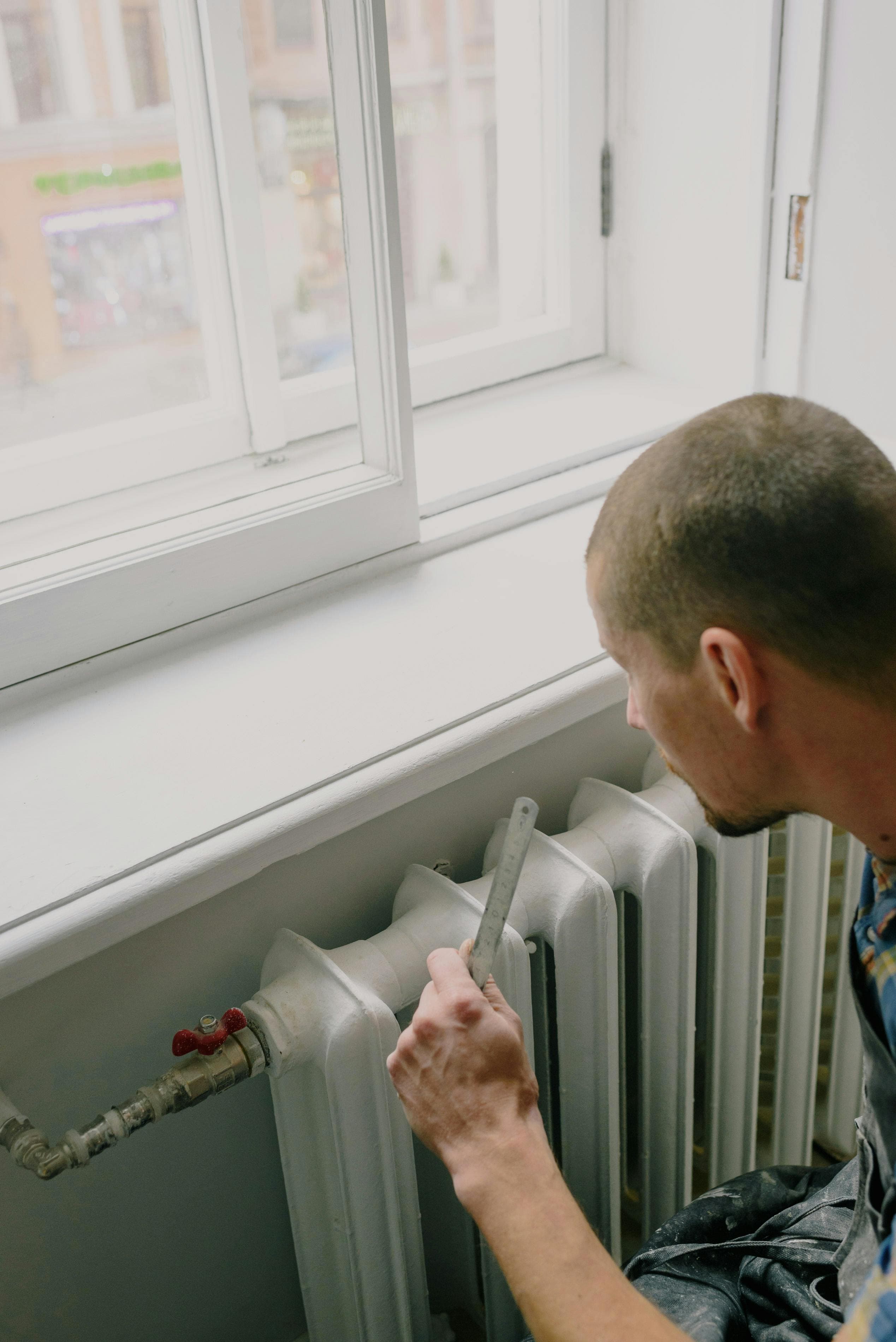 Plumber working on an indoor heating unit